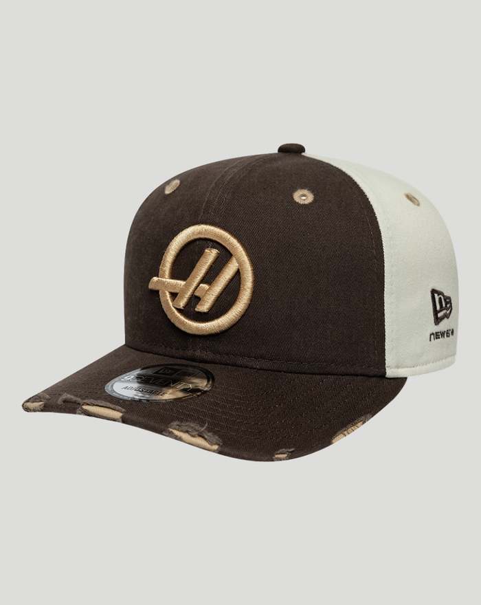 Haas Team Austin 9Seventy cap in dark brown with beige side panel and gold embroidered logo on the front.