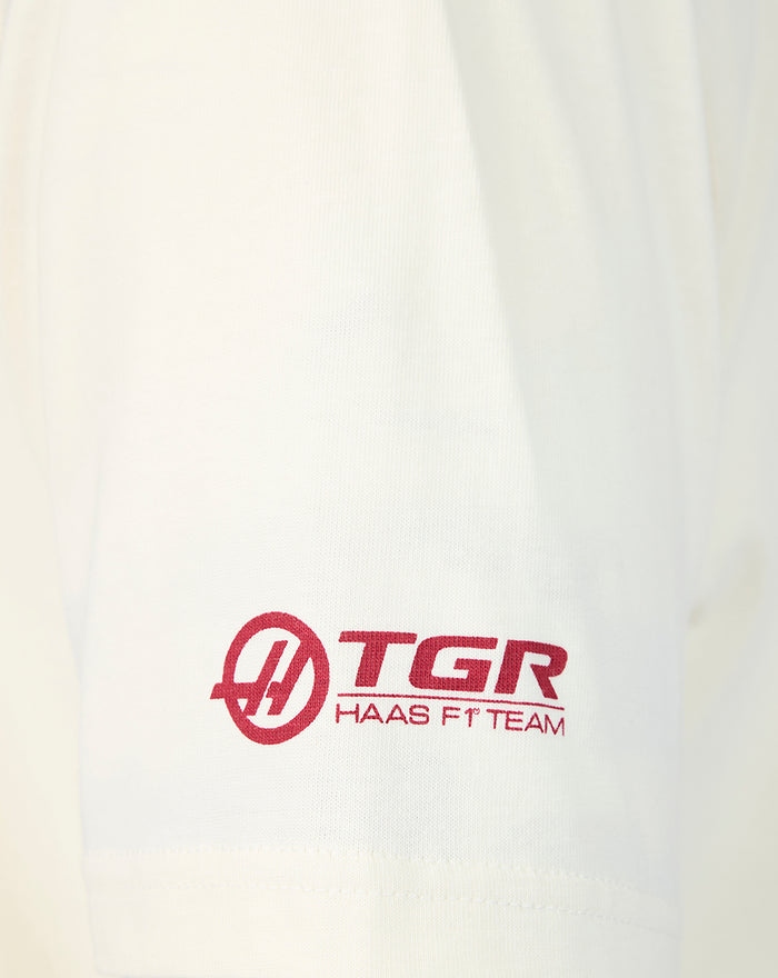 White T shirt sleeve with red TGR Haas F1 Team logo near the hem.