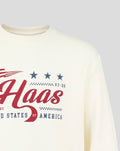 Close up of cream Haas Team USA flag sweater front with bold red Haas script and blue stars.