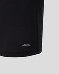 Lower sleeve hem of black Haas polo showing AERTEK logo and red zigzag cuff trim.