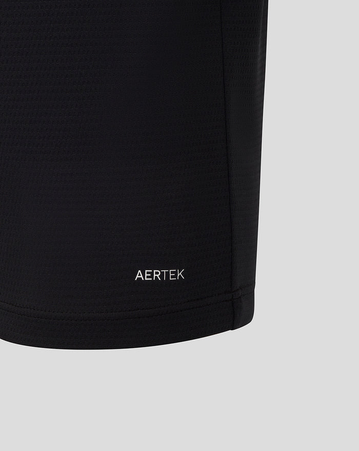Lower sleeve hem of black Haas polo showing AERTEK logo and red zigzag cuff trim.