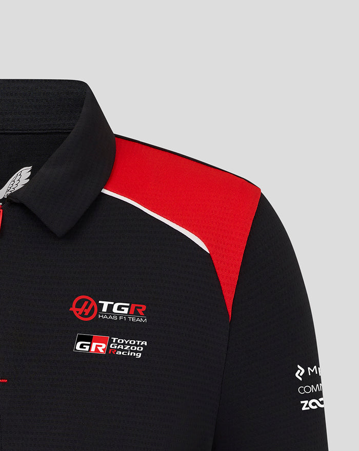 Front view of Haas Team Junior Polo showing red shoulder panel and concealed zip placket with Haas branding