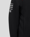 Sleeve detail showing white sponsor logos and a red shoulder panel on the hoodie.