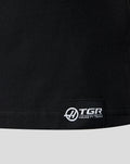 Woven label with sponsor branding TGR Haas F1 Team at the lower left front hem.