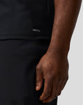 Close-up of lower left hem showing AERTEK branding on the Haas Team polo.