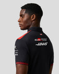 Model wearing Official Haas Team men's short sleeve polo in black with red shoulder stripe and back branding
