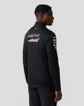 Back view of a male model wearing Haas Team Quarter Zip Midlayer showing large logos on the back and red shoulder panels