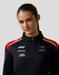 Female model wearing Unisex Official Haas Team Quarter Zip Midlayer with red accents and branding on the chest