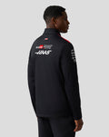 Back view of black Haas Team Soft Shell Jacket with large Haas branding and a small American flag near the collar