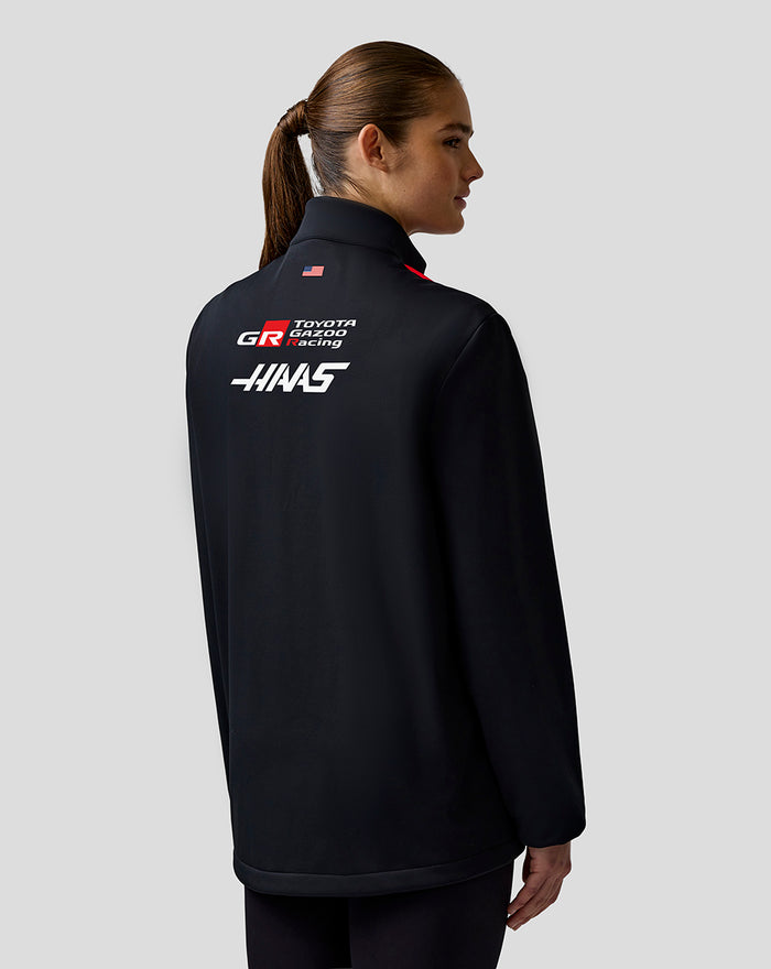 Back view highlighting bold Haas branding across the back of the jacket and subtle sponsor logos on the sleeve