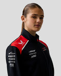 Model wearing the Haas Team Soft Shell Jacket in black with red shoulder panels and front sponsor logos.
