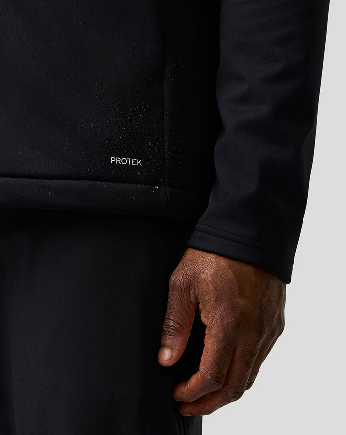 Close up of the black ProTek Soft Shell Jacket fabric with the ProTek label on the front.