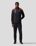 Front view of a model wearing the Haas Team Gilet with black fabric and red shoulder panels
