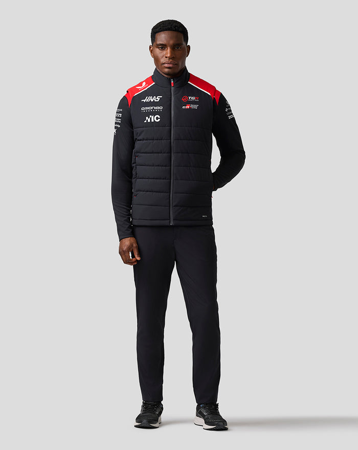 Front view of a model wearing the Haas Team Gilet with black fabric and red shoulder panels