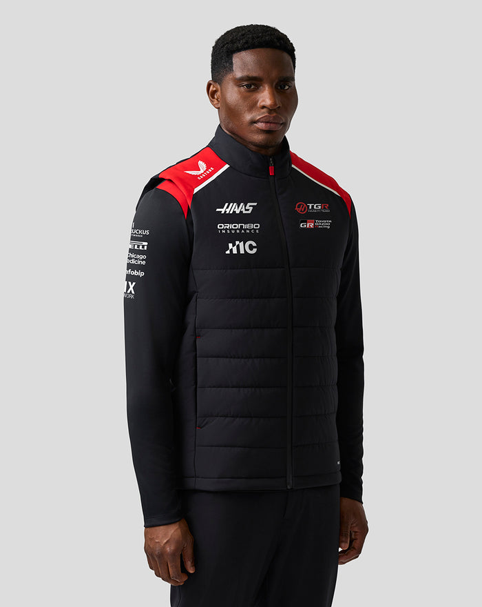 Male model wearing Official Haas Team Unisex Gilet with black body and red shoulder panels.