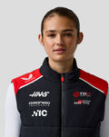 Front view of a female model wearing Official Haas Team Unisex Gilet in black with red shoulders and team branding.