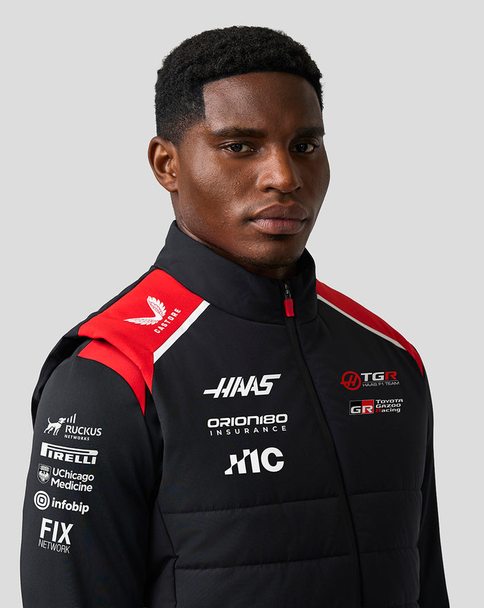 Model wearing Haas Team Unisex Gilet showing stitched quilted front panels and branding.