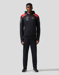 Front view of a black Haas Team pullover hoodie with red shoulder panels and sponsor logos.