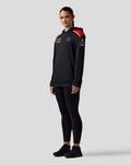 Three quarter front view of black Haas Team pullover hoodie with red shoulder panels and logos.