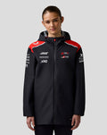 Back view of Haas Team water resistant jacket on a female model, large branding on the back and red shoulder panels.