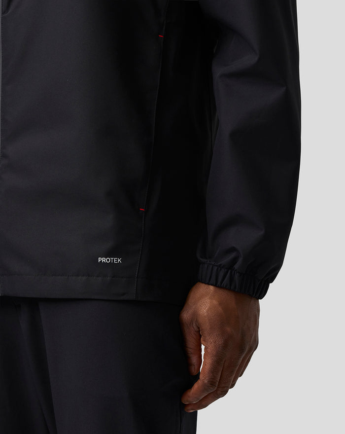 Detail of the jacket sleeve and hem showing the PROTEK branding and elastic cuff.