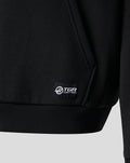 Close up of black hoodie hem showing woven label with Haas F1 Team sponsor branding at lower left front