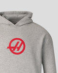 Close-up of red Haas logo on the chest of the grey marl pullover hoodie