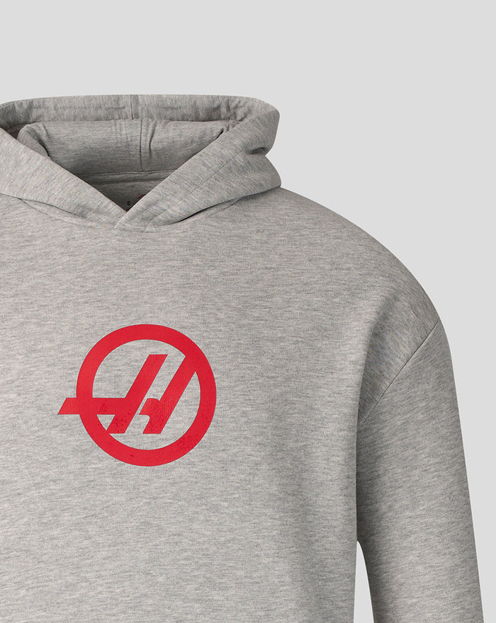 Close-up of red Haas logo on the chest of the grey marl pullover hoodie