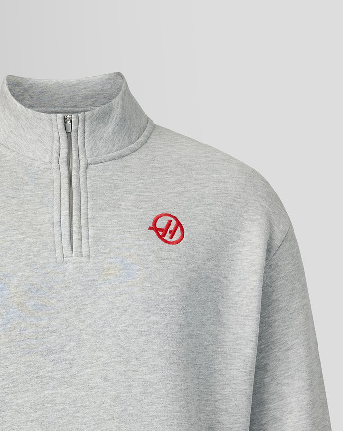 Grey heather quarter zip top with red Haas logo on the left chest and zip placket at the collar.