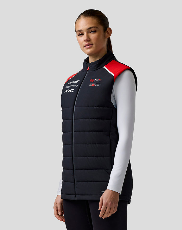 Female model wearing Official Haas Team gilet in black with red shoulder panels and chest branding